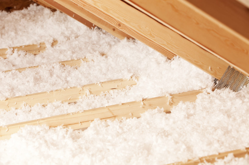 Loose-fill fiberglass insulation along the floor of an attic