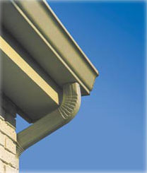 Gutter guards installed at the corner of a home's roof.