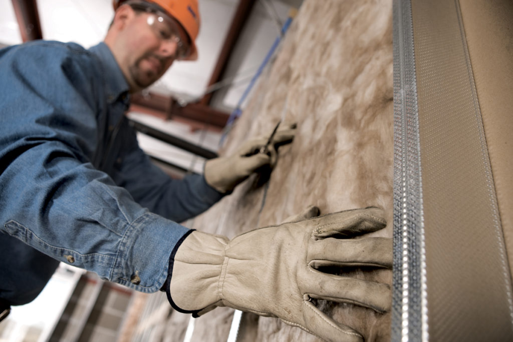 IBP Technicians Installing Insulation in an Agricultural Building